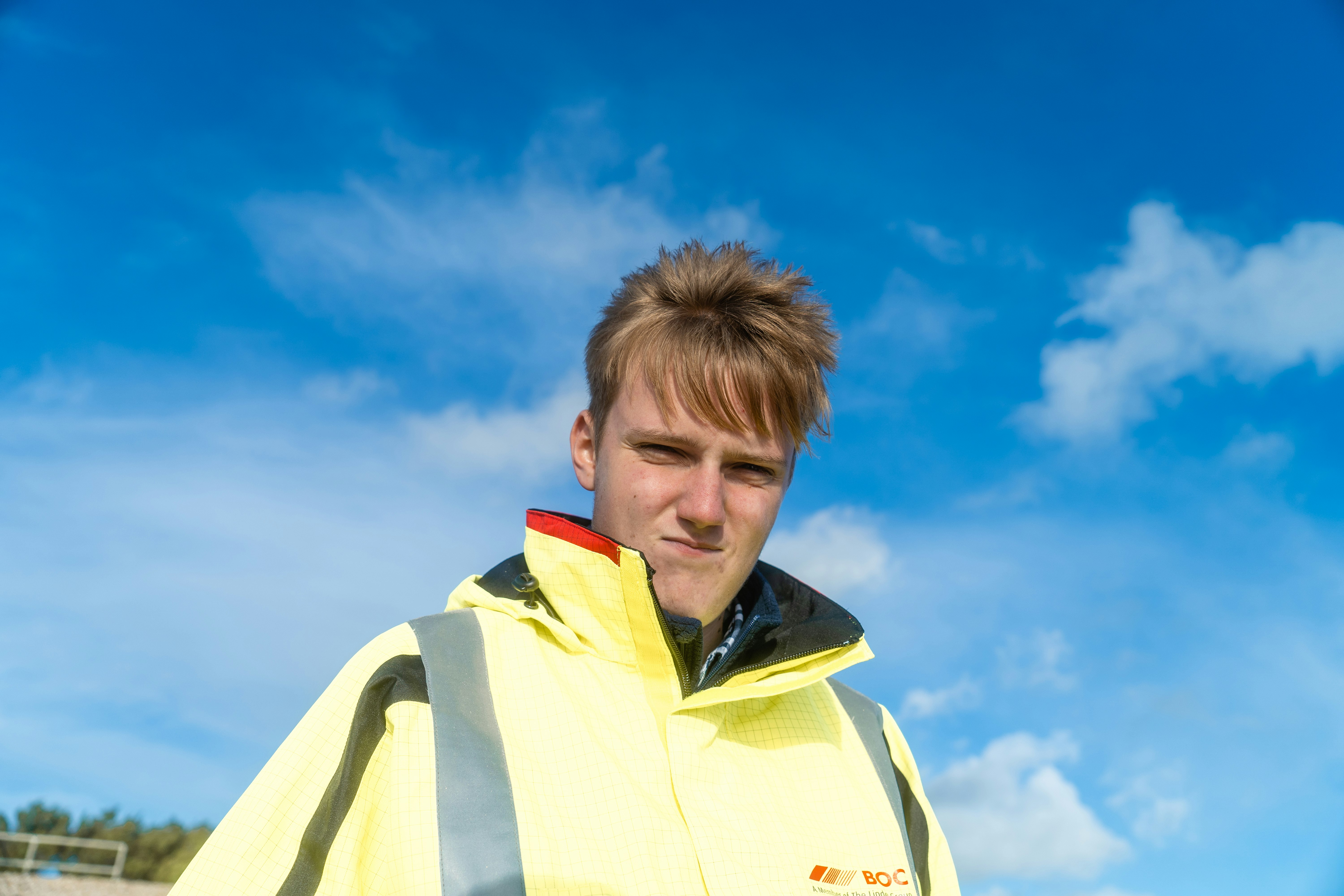 man in yellow and black zip up jacket under blue sky during daytime